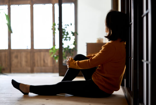 Drug and Alcohol Rehab Birmingham, West Midlands. Woman sitting on the floor inside